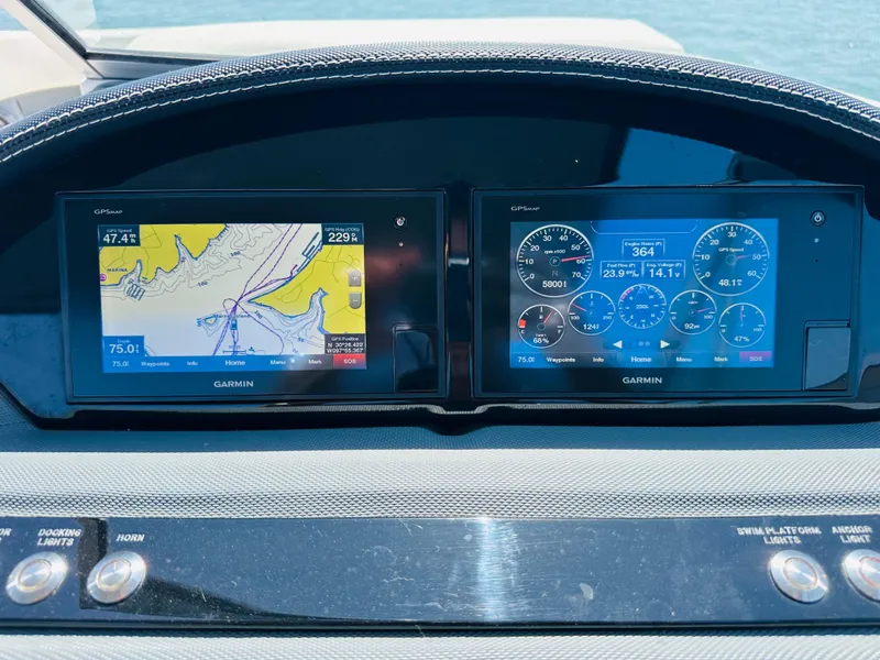 Slide: The Image of Dashboard of a 2018 Cobalt 23SC boat with Garmin navigation displays. - 23