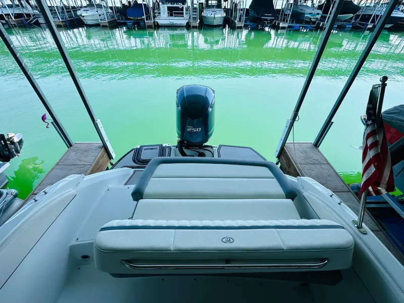 Slide: The Image of 2018 Cobalt 23SC boat with outboard motor docked on vibrant green water. - 31