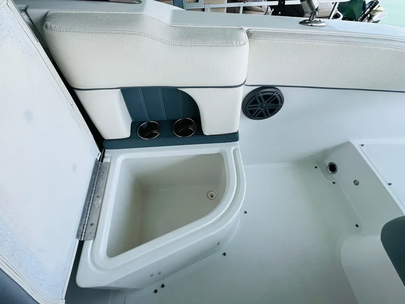 Slide: The Image of 2018 Cobalt 23SC boat interior with storage compartment and speaker. - 34
