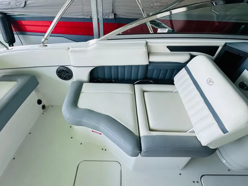 Slide: The Image of 2018 Cobalt 23SC boat interior with white and gray seating. - 38