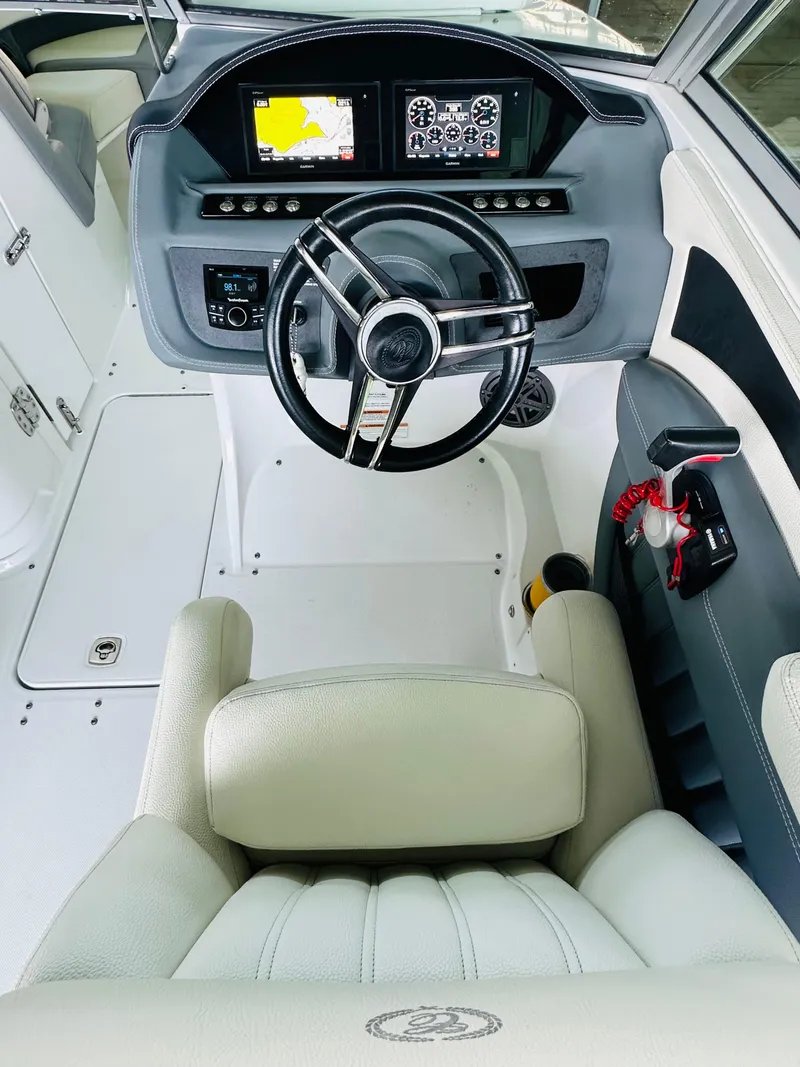 Slide: The Image of 2018 Cobalt 23SC boat cockpit with steering wheel and control panel. - 41