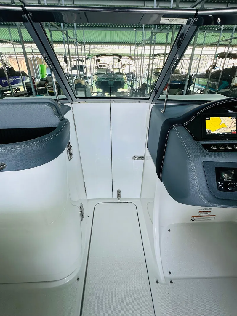 Slide: The Image of 2018 Cobalt 23SC boat interior with modern dashboard and seating. - 46