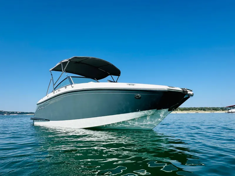 Slide: The Image of 2018 Cobalt 23SC boat on calm water under clear blue sky. - 6