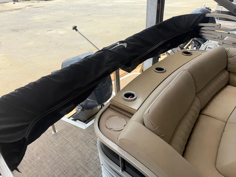 Slide: The Image of 2014 Bennington 2550 RCB boat interior with tan seating and cup holders. - 11