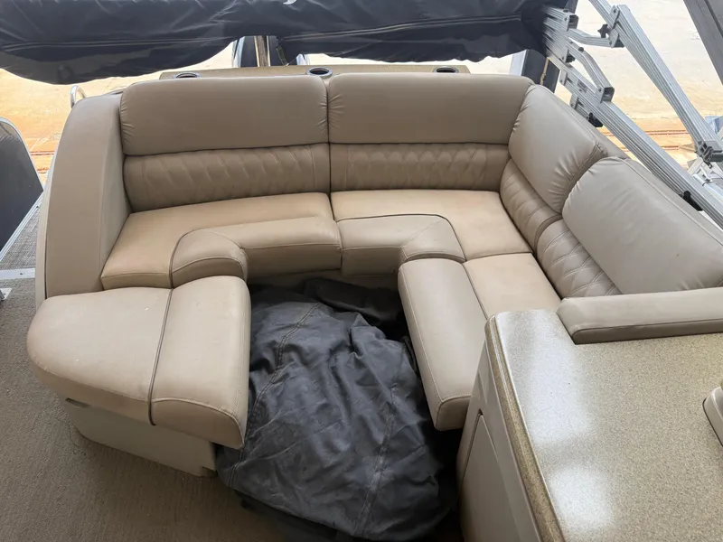 Slide: The Image of 2014 Bennington 2550 RCB boat interior with beige leather seating arrangement. - 12