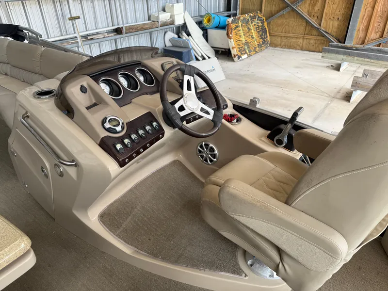Slide: The Image of 2014 Bennington 2550 RCB boat interior with steering wheel and control panel. - 13