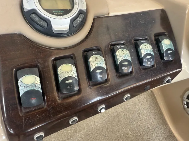 Slide: The Image of Control panel of a 2014 Bennington 2550 RCB boat with various switches and dials. - 16