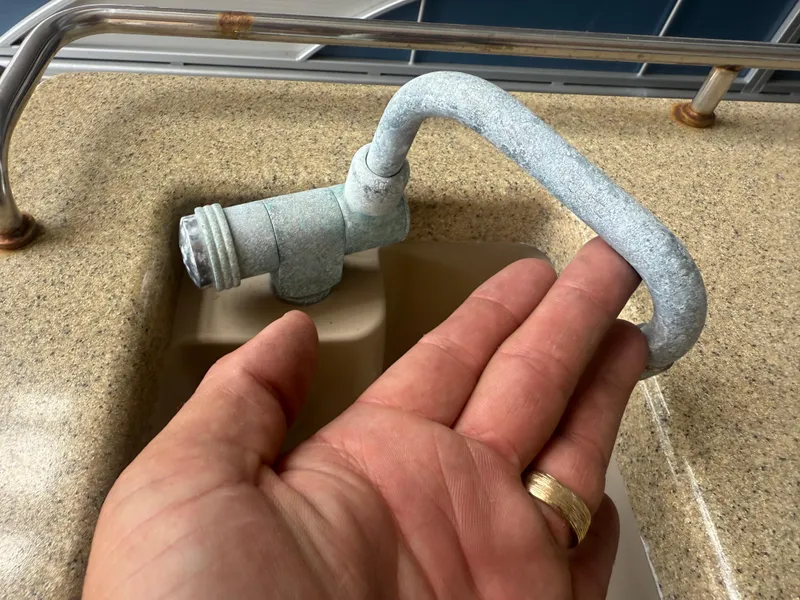 Slide: The Image of Hand inspecting corroded faucet on Bennington 2550 RCB boat, 2014 model. - 22