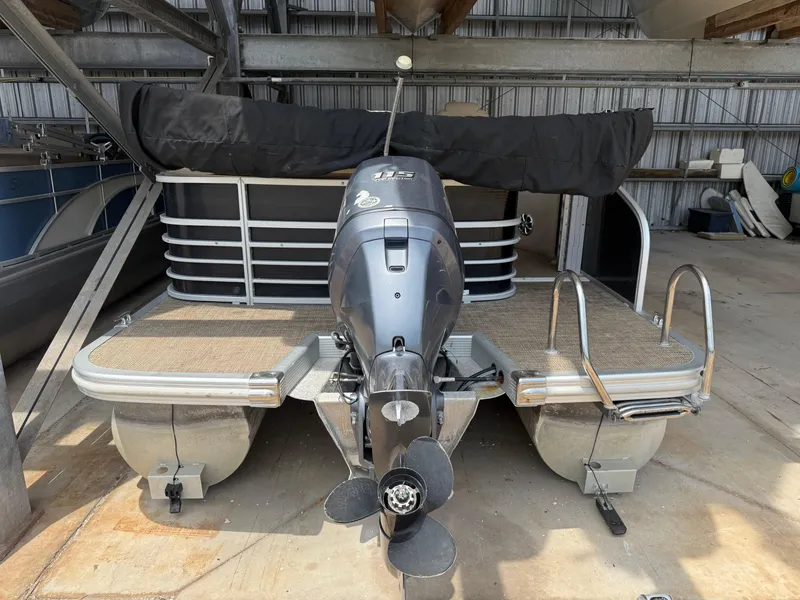 Slide: The Image of 2014 Bennington 2550 RCB pontoon boat with outboard motor in storage. - 5