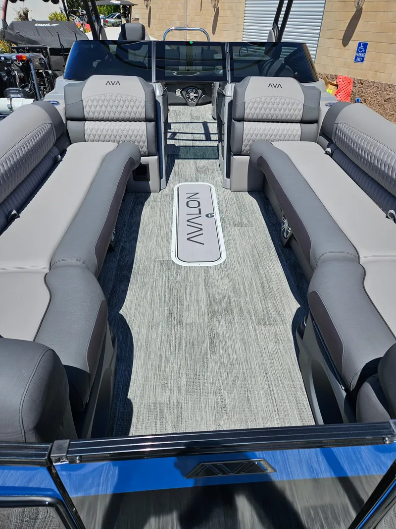 Slide: The Image of 2025 Avalon Excalibur LTD Elite Windshield 27FT boat interior with luxurious seating. - 3