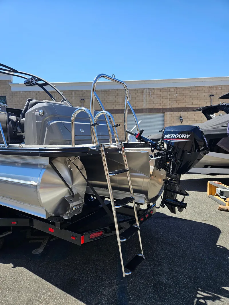 Slide: The Image of 2025 Avalon Excalibur LTD Elite Windshield 27FT boat with Mercury outboard motor and ladder. - 6