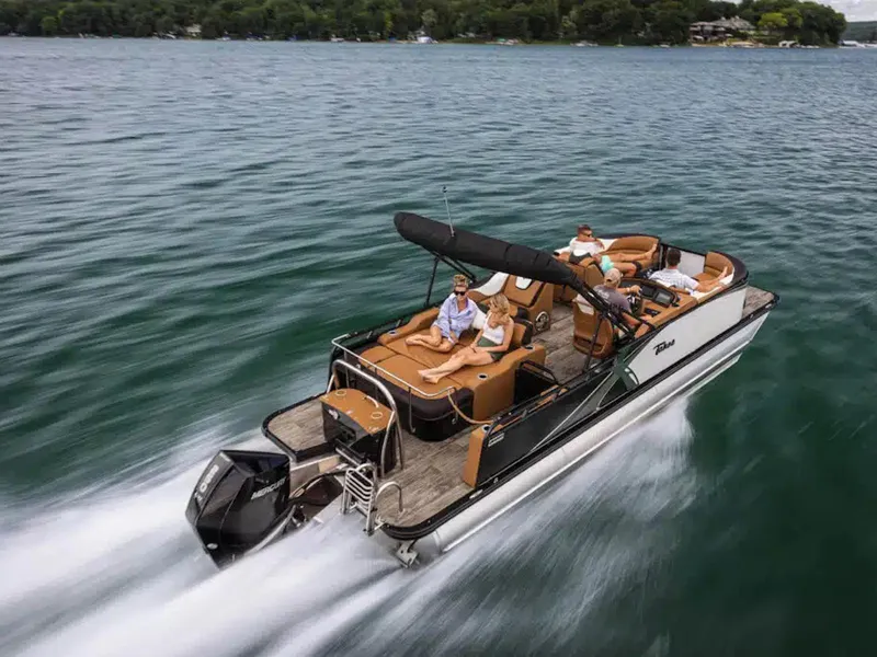 Slide: The Image of 2025 Tahoe LTZ boat cruising on a lake with passengers enjoying the ride. - 18