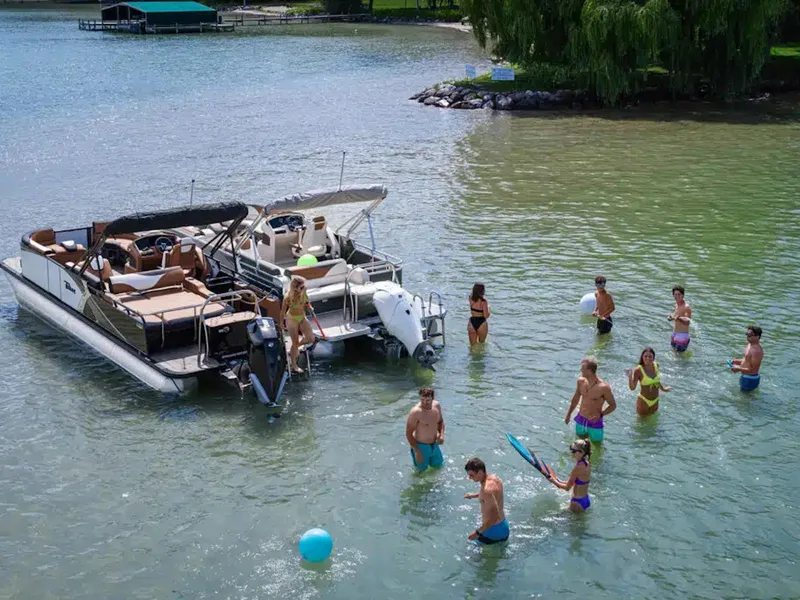 Slide: The Image of People enjoying water activities near a 2025 Tahoe LTZ boat. - 24
