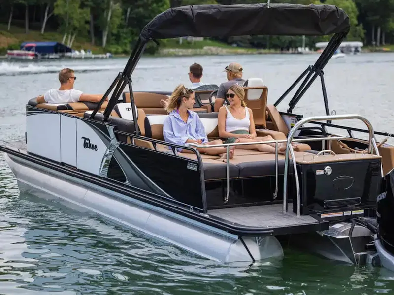 Slide: The Image of 2025 Tahoe LTZ pontoon boat with passengers enjoying a lake outing. - 26