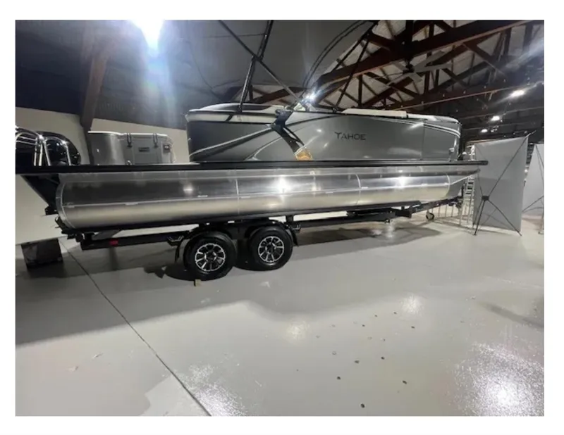 Slide: The Image of 2025 Tahoe LTZ pontoon boat on trailer in indoor showroom. - 7