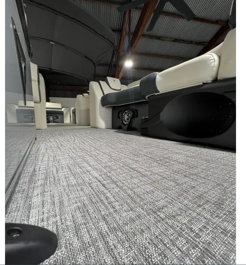 Slide: The Image of 2025 Tahoe CASCADE interior with modern seating and carpeted flooring in a spacious setting. - 2