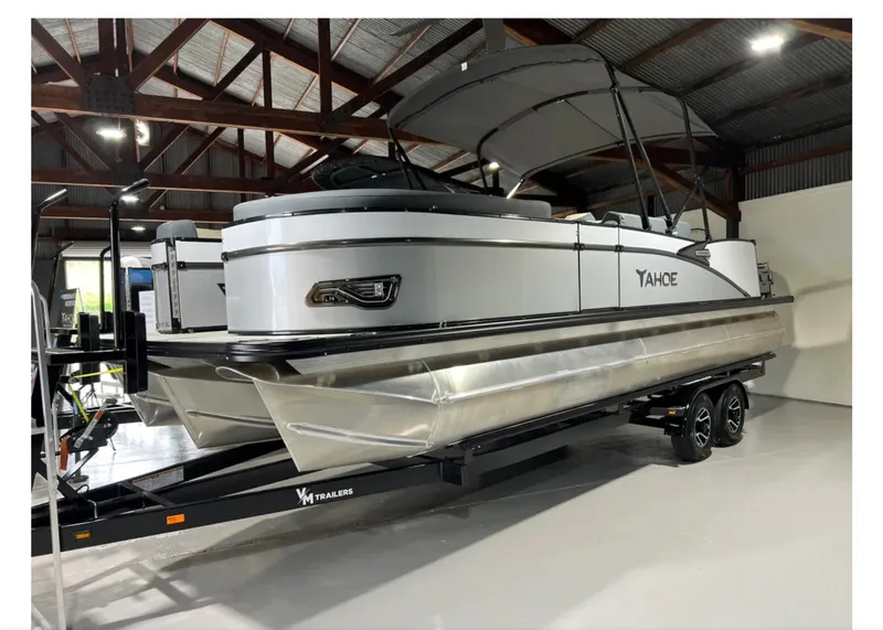 Slide: The Image of 2025 Tahoe CASCADE pontoon boat on trailer in indoor storage facility. - 4