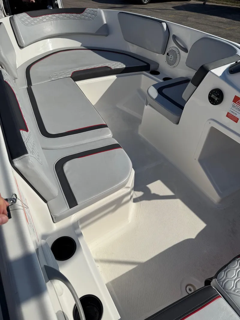 Slide: The Image of 2022 Bayliner Element M15 boat interior with cushioned seating and modern design. - 2