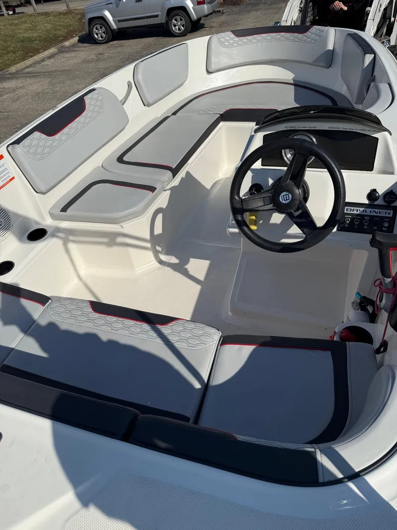 Slide: The Image of 2022 Bayliner Element M15 boat interior with seating and steering wheel. - 4