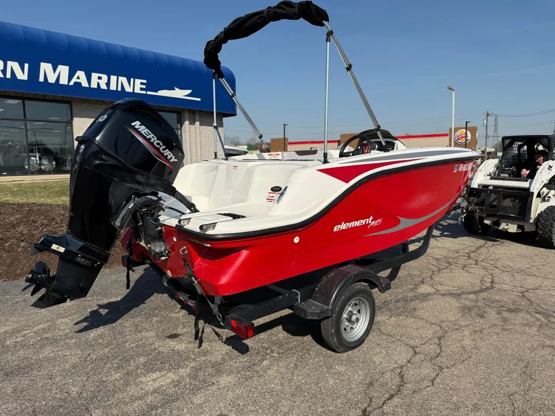 Slide: The Image of 2022 Bayliner Element M15 boat with Mercury engine, parked outside a marine dealership. - 6