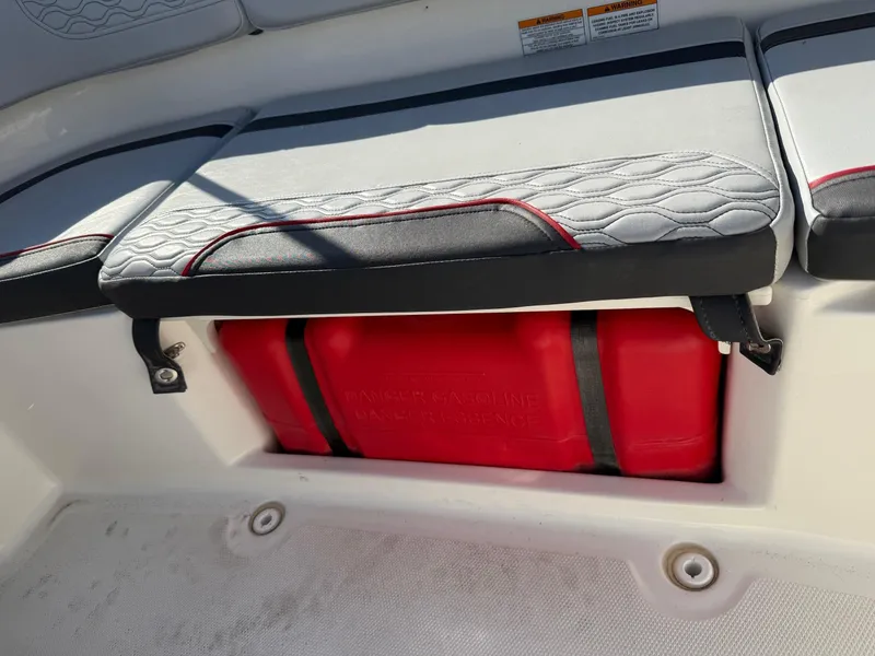 Slide: The Image of 2022 Bayliner Element M15 boat seat with red storage compartment underneath. - 7