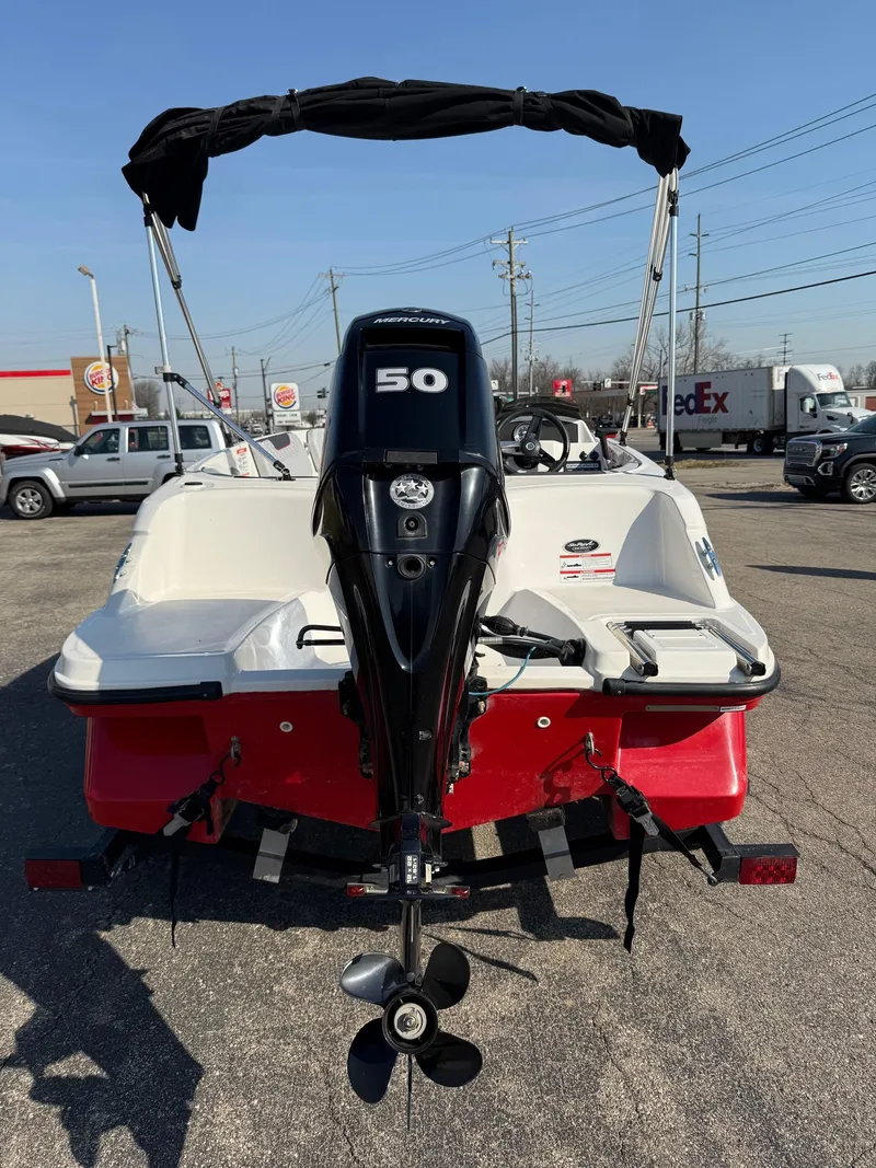 Slide: The Image of 2022 Bayliner Element M15 boat with 50 HP outboard motor, red and white design. - 8