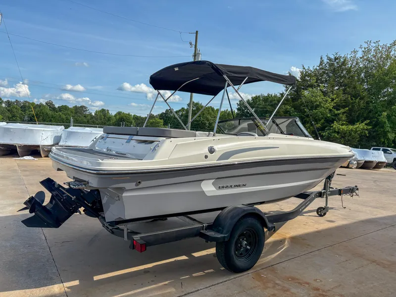 Slide: The Image of 2021 Bayliner VR4 boat on trailer with canopy, parked outdoors. - 1