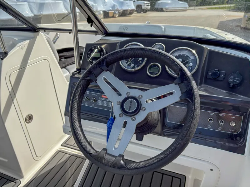 Slide: The Image of 2021 Bayliner VR4 boat dashboard with steering wheel and gauges. - 12