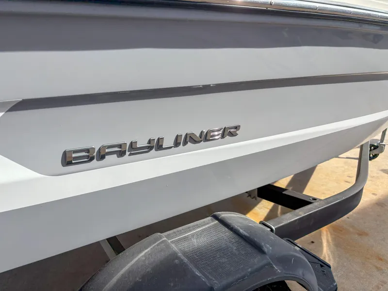 Slide: The Image of 2021 Bayliner VR4 boat side view with logo on trailer. - 2