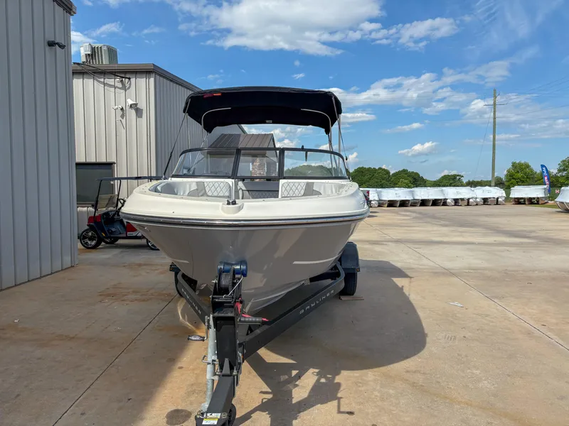 Slide: The Image of 2021 Bayliner VR4 boat on trailer, parked outdoors under a clear blue sky. - 3