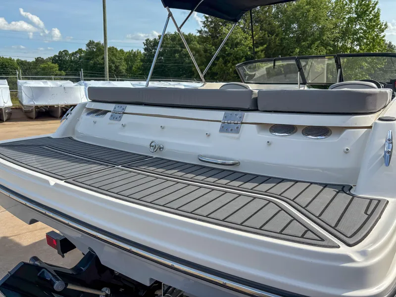 Slide: The Image of 2021 Bayliner VR4 boat with spacious rear deck and seating, parked outdoors. - 6