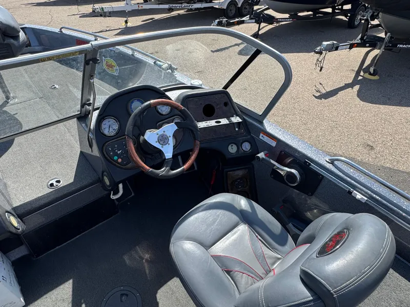 Slide: The Image of 2004 Ranger 619 VS Fisherman boat interior with steering wheel and dashboard controls. - 6