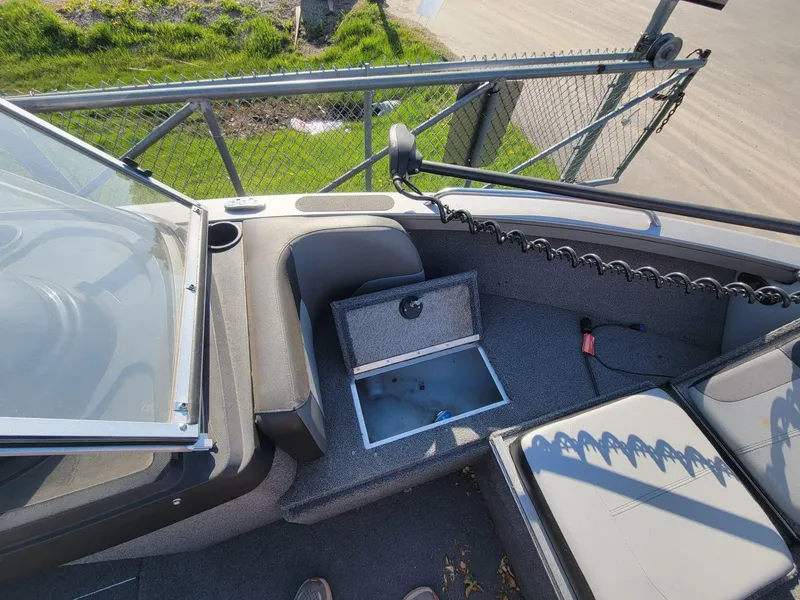 Slide: The Image of 2018 Crestliner 1950 Sportfish SST boat interior with open storage compartment and seating. - 10