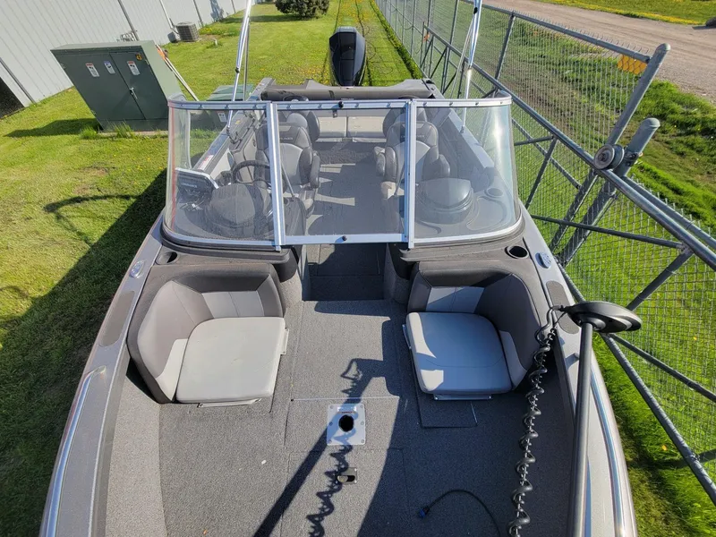Slide: The Image of 2018 Crestliner 1950 Sportfish SST boat, spacious interior, windshield, outdoor setting. - 14