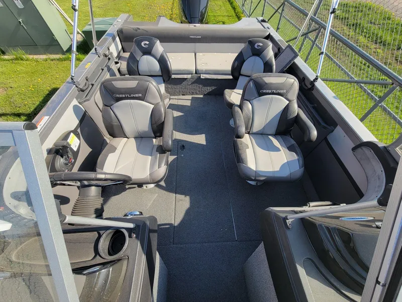 Slide: The Image of 2018 Crestliner 1950 Sportfish SST interior with four seats and steering wheel. - 16
