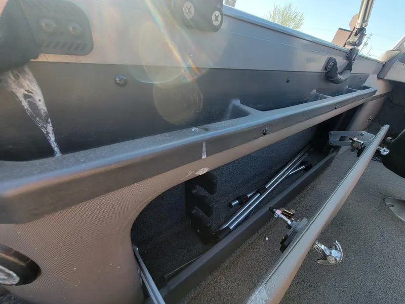 Slide: The Image of 2018 Crestliner 1950 Sportfish SST interior storage compartment with fishing rod holders. - 20