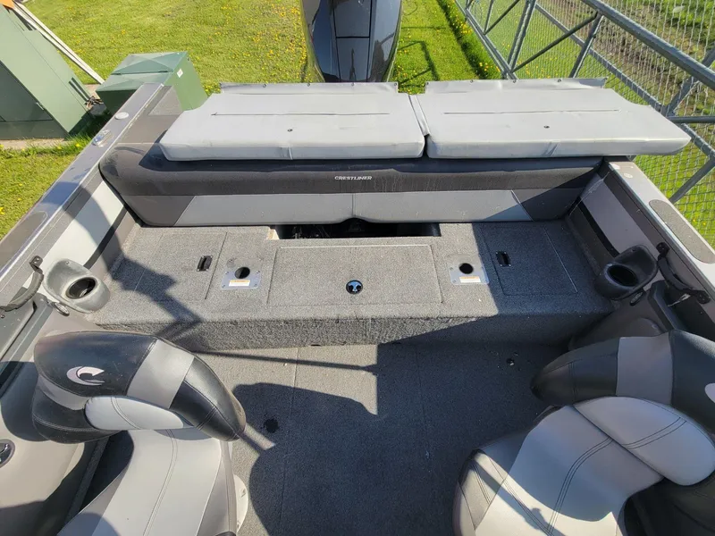 Slide: The Image of 2018 Crestliner 1950 Sportfish SST interior with seating and storage compartments. - 21