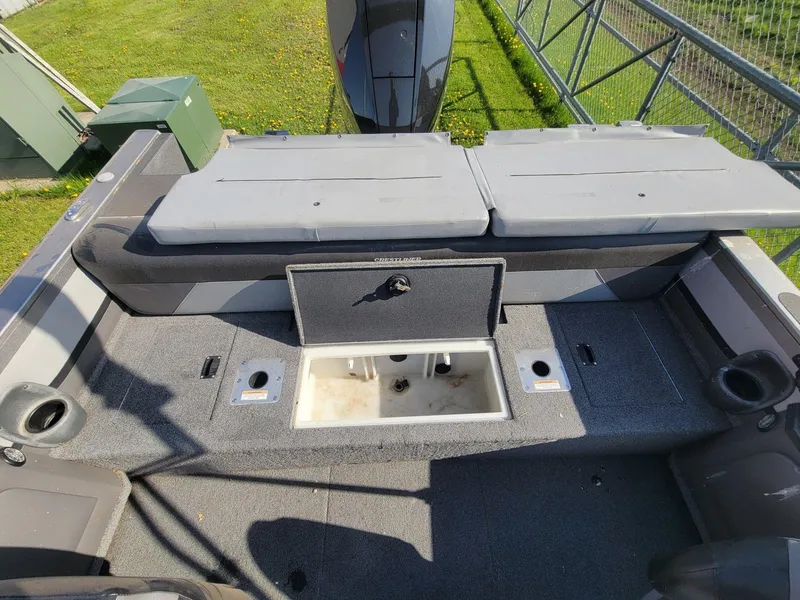 Slide: The Image of 2018 Crestliner 1950 Sportfish SST boat interior with storage compartments and seating. - 22