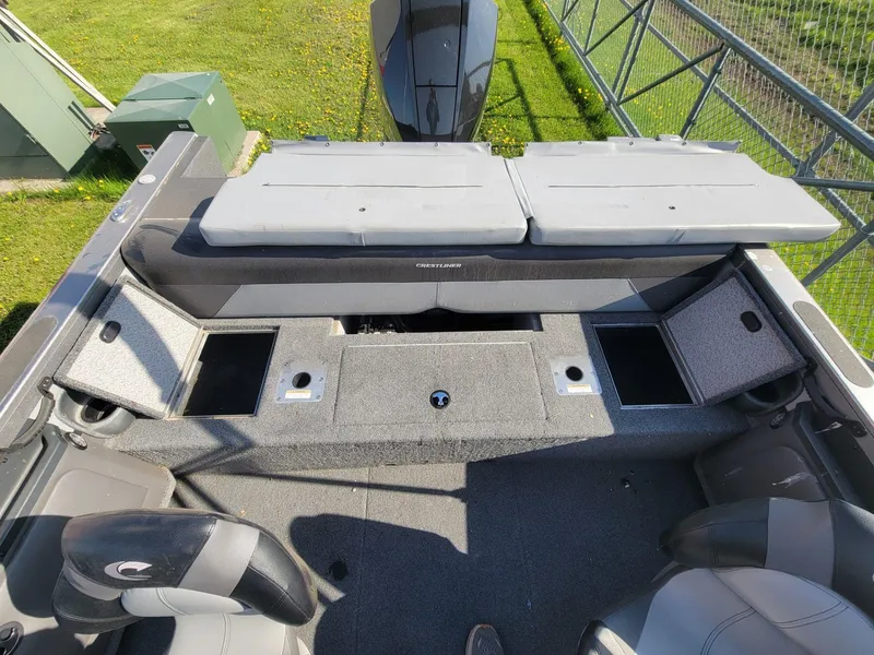 Slide: The Image of 2018 Crestliner 1950 Sportfish SST boat interior with seating and storage compartments. - 23
