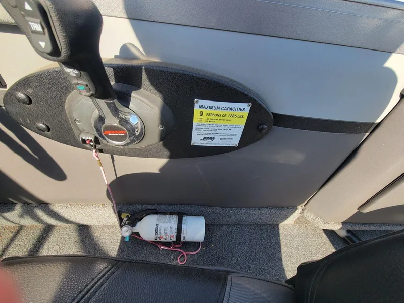 Slide: The Image of Interior of 2018 Crestliner 1950 Sportfish SST showing control panel and fire extinguisher. - 26