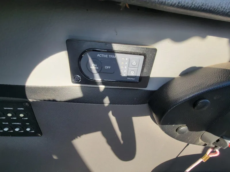Slide: The Image of Active trim control panel on 2018 Crestliner 1950 Sportfish SST boat dashboard. - 27