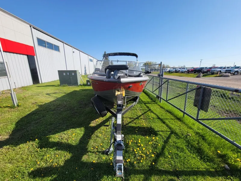 Slide: The Image of 2018 Crestliner 1950 Sportfish SST boat on trailer, parked outside a building. - 3
