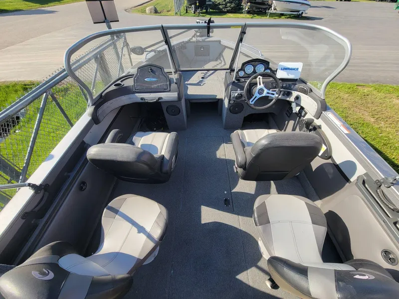 Slide: The Image of 2018 Crestliner 1950 Sportfish SST boat interior with seating and steering console. - 4