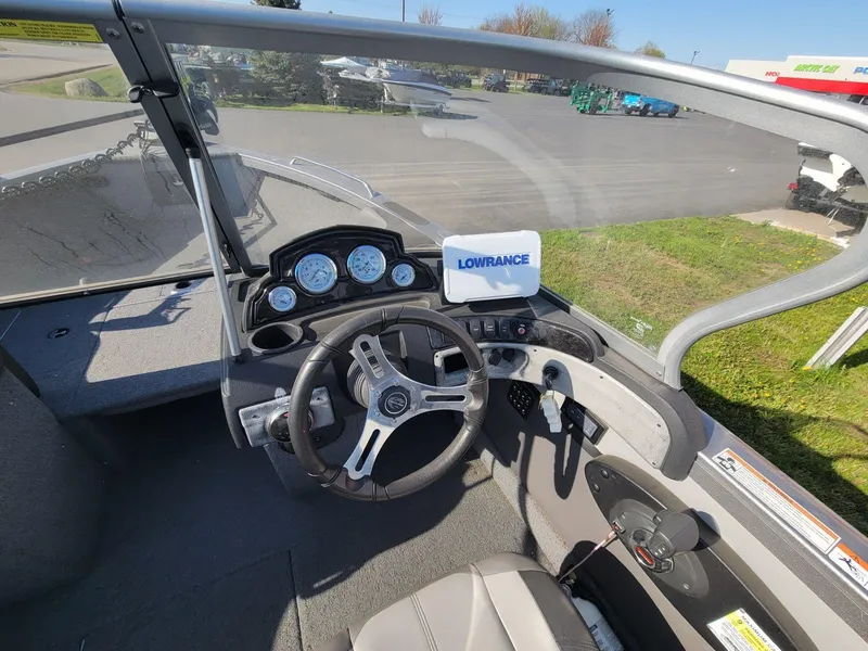 Slide: The Image of 2018 Crestliner 1950 Sportfish SST dashboard with steering wheel and Lowrance navigation system. - 6