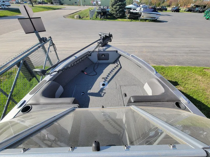 Slide: The Image of 2018 Crestliner 1950 Sportfish SST boat interior with trolling motor, parked on pavement. - 8