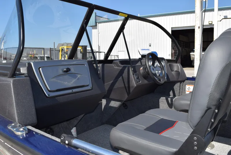 Slide: The Image of 2024 Tracker Pro Guide V-16 WT boat interior with steering wheel and seating. - 10