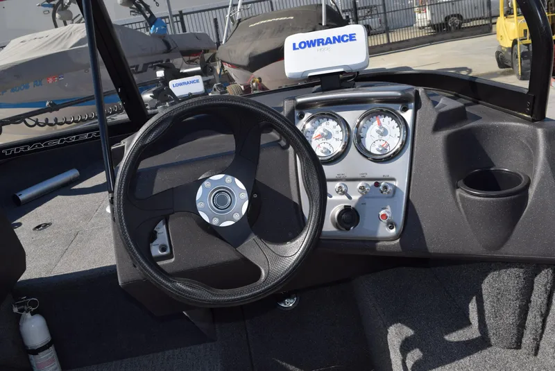 Slide: The Image of 2024 Tracker Pro Guide V-16 WT boat dashboard with steering wheel and Lowrance electronics. - 11