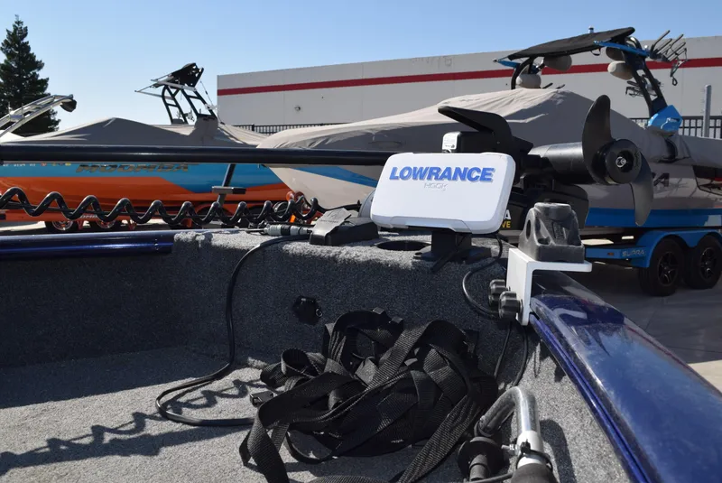 Slide: The Image of 2024 Tracker Pro Guide V-16 WT boat with Lowrance equipment, parked outdoors. - 4