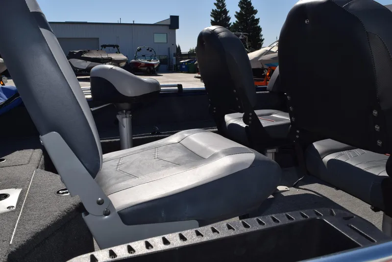 Slide: The Image of 2024 Tracker Pro Guide V-16 WT boat interior with gray seating and storage compartments. - 7