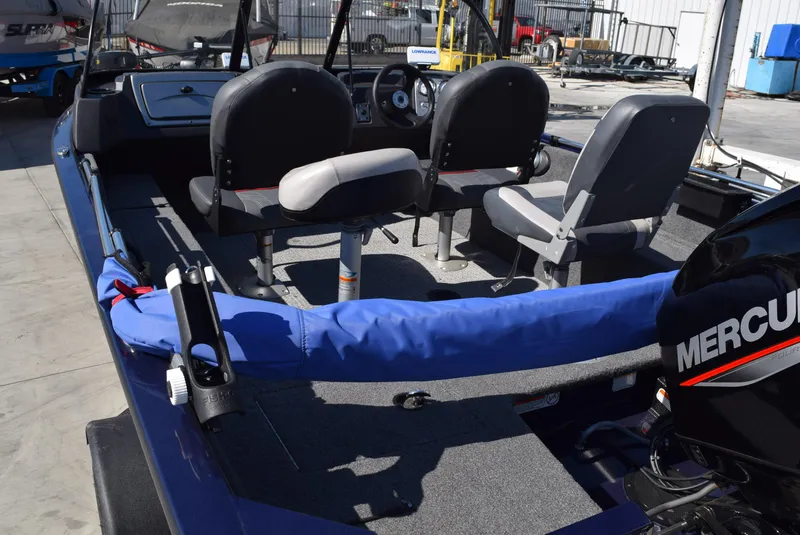 Slide: The Image of 2024 Tracker Pro Guide V-16 WT boat interior with seating and Mercury engine. - 9